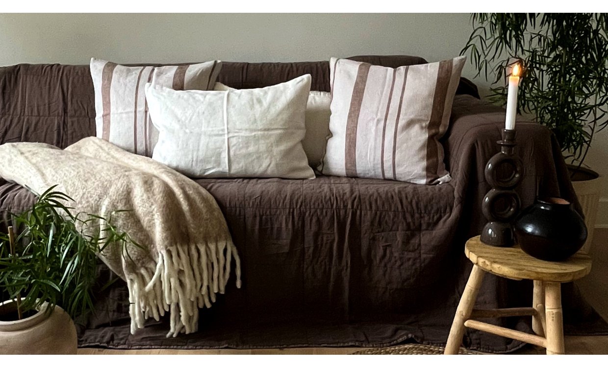 Sofa med puder, t�pper og levende lys